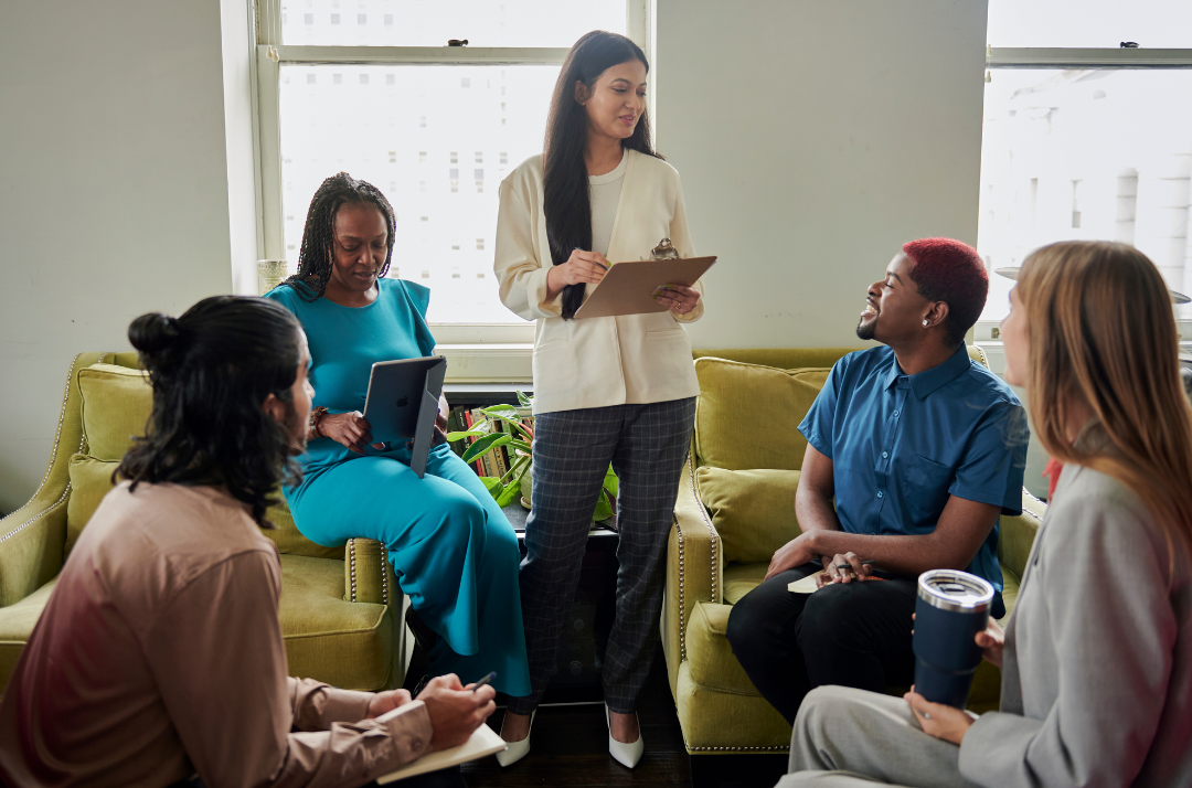 Diverse team of professionals collaborating in a modern office setting, symbolizing leadership development, employee engagement, and small business growth.